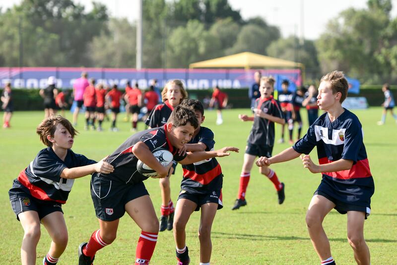 A Dubai College player runs with the ball at BSAK 7s tournament held in Zayed Cricket Stadium, Abu Dhabi. Khushnum Bhandari / The National