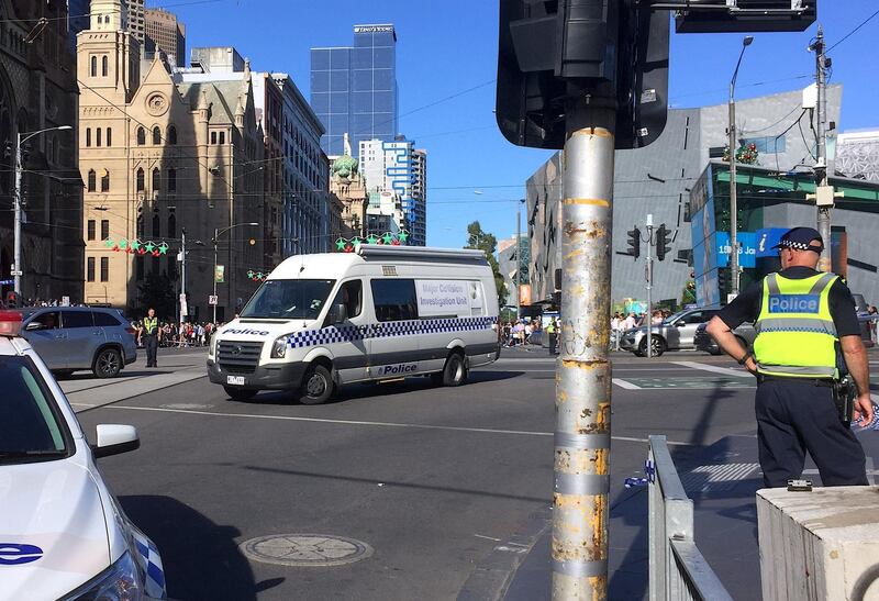Members of the public stand behind police tape after Australian police said on Thursday they have arrested the driver of a vehicle that ploughed into pedestrians at a crowded intersection near the Flinders Street train station in central Melbourne. Melanie Burton / Reuters