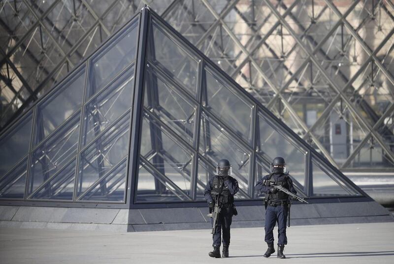 Police officers stand guard at the Pyramid of the Louvre Museum, near where soldiers shot a man who attacked them with a machete  on February 3, 2017. Ian Langsdon / EPA