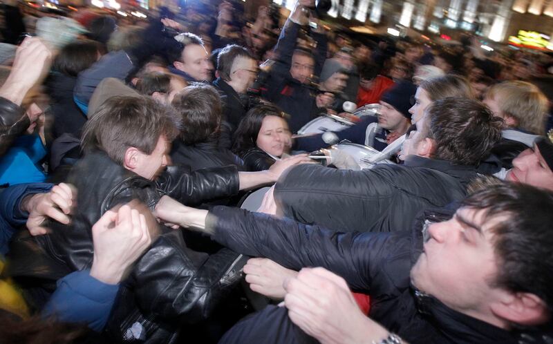 Opposition activists, left, and members of pro-Kremlin youth movements scuffle during demonstrations in Triumphal Square in Moscow, Russia, Tuesday, Dec. 6, 2011. Police clashed Tuesday on a central Moscow square with demonstrators trying to hold a second day of protests against alleged vote fraud in Russia's parliamentary elections. (AP Photo/Ivan Sekretarev) *** Local Caption ***  Russia Election Protest.JPEG-09c36.jpg