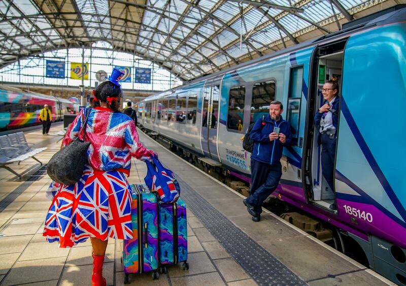 A fan arrives at Liverpool Lime Street train station. PA