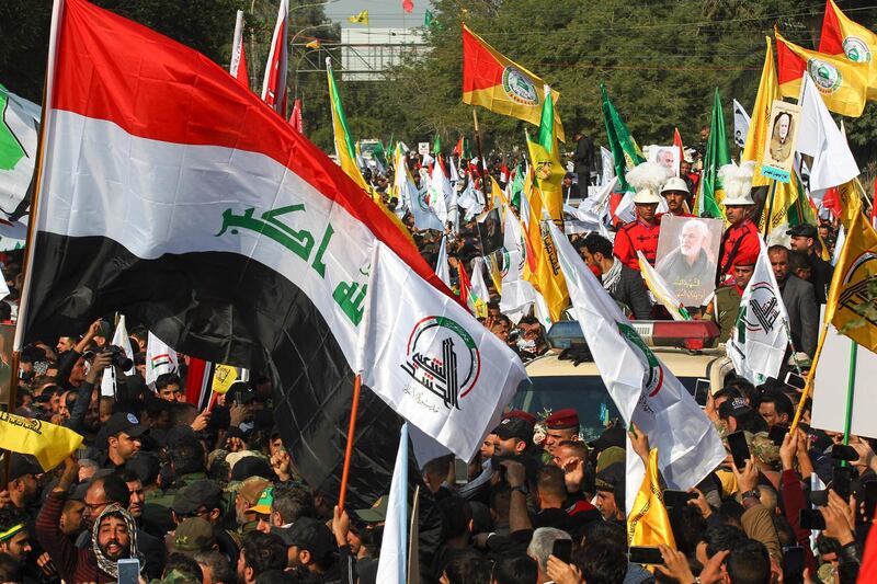 Mourners surround a car carrying the coffin of Iraqi paramilitary chief Abu Mahdi al-Muhandis during a funeral procession, for him and nine others, in Baghdad's district of al-Jadriya, near the high-security Green Zone.  AFP