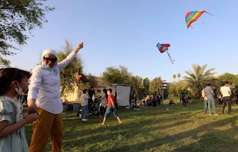 A woman flies a kite during the festival at the Abu Nawas park in Baghdad.  EPA
