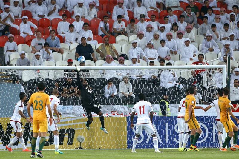 UAE goalkeeper Khalid Essa, centre, jumps to clear the ball ahead of Australia’s Tomas Rogic. Karim Sahib / AFP