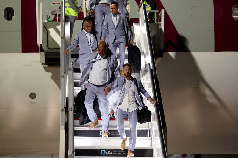 Neymar and the Brazil squad and staff disembark from an aircraft at Hamad International Airport. Getty