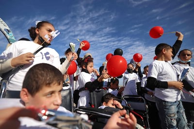 Palestinian children with disabilities take part in an event to mark the International Day for Persons with Disabilities in Gaza City, on November 30, 2021. AFP