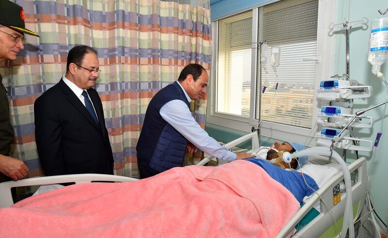 Egyptian President Abdel Fattah al-Sisi (3rd L) visits police officer Mohamed El-Hayes who was rescued after being kidnapped during an attack in the Western Desert, at a military hospital in Cairo, Egypt, November 1, 2017 in this handout picture courtesy of the Egyptian Presidency. The Egyptian Presidency/Handout via REUTERS ATTENTION EDITORS - THIS IMAGE WAS PROVIDED BY A THIRD PARTY