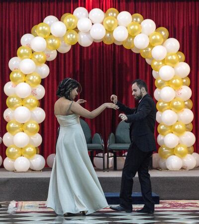 Rimon Ayyad, 28, dance with his wife  Marina, 19, from Cairo by a giant arc of white and yellow balloon during a celebration of their marriage held at a hall in the compound of the Greek Orthodox Church of Saint Porphyrius in Gaza City. She moved to Gaza to be with him and their wedding is one of the few unions in the Christian community this year.  

ÒIÕm more optimistic this year,Ó said the new groom, who studied nursing and hospital administration but, like so many here, is now unemployed. ÒIÕve just started my new life.Ócompound at the Church of Saint Porphyrius in Gaza City on December 20,2018.(Photo by Heidi Levine for The National).