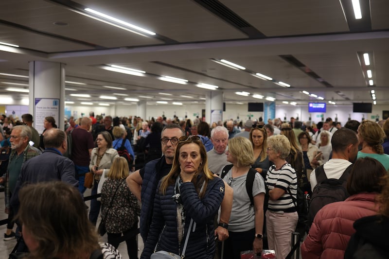 Passengers queue at Gatwick Airport as electronic passport gates fail across the UK in 2023