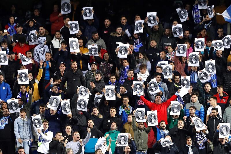 epa08129378 Malaga FC supporters hold pictures of Sheikh Abdullah Ben Nasser Al Zani, owner of the soccer club, during a match between Malaga FC and SD Ponferradina at la Rosaleda Stadium in Malaga, Spain, 14 January 2020 (issued 15 January 2020). Fans protested against the club's owner as a response to the destitution of the team's head coach Victor Sanchez del Amo.  EPA/JORGE ZAPATA