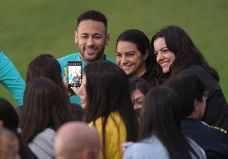 Brazil's Neymar poses with fans during a training session in Rio de Janeiro. AFP