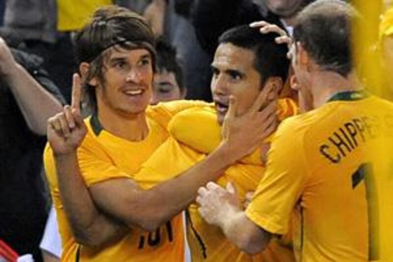 Tim Cahill, centre, is congratulated by his Australian teammates after scoring the only goal against Oman in today's Asian Cup qualifier.