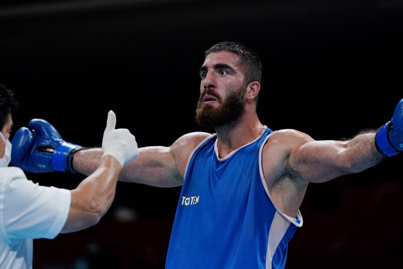 France's Mourad Aliev reacts after losing by disqualification against Britain's Frazer Clarke.