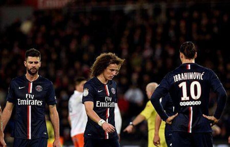 Paris Saint-Germain midfielder Thiago Motta, left, defender David Luiz and forward Zlatan Ibrahimovic react during their French Ligue 1 football match against Montpellier on December 20, 2014 at the Parc des Princes Stadium in Paris. AFP PHOTO / FRANCK FIFE