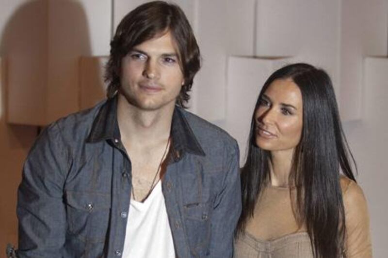 The actor (and model) Ashton Kutcher, left, with his wife, the actress Demi Moore, at the Colcci fall-winter 2011 collection at Sao Paulo Fashion Week, in Sao Paulo, Brazil.