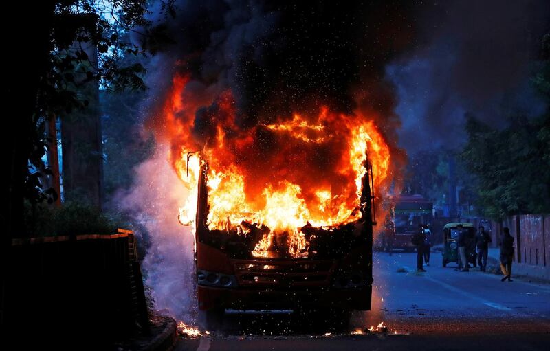 A passenger bus burns after it was set on fire by demonstrators during a protest against a new citizenship law, in New Delhi, India, December 15, 2019. REUTERS/Adnan Abidi TPX IMAGES OF THE DAY