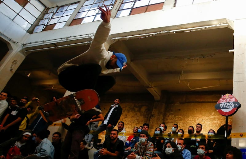 Spectators, some wearing face masks, watch a skateboarder compete at the Red Bull Mind The Gap skateboarding at Townhouse Gallery, near Tahrir Square, in Cairo, Egypt. Reuters