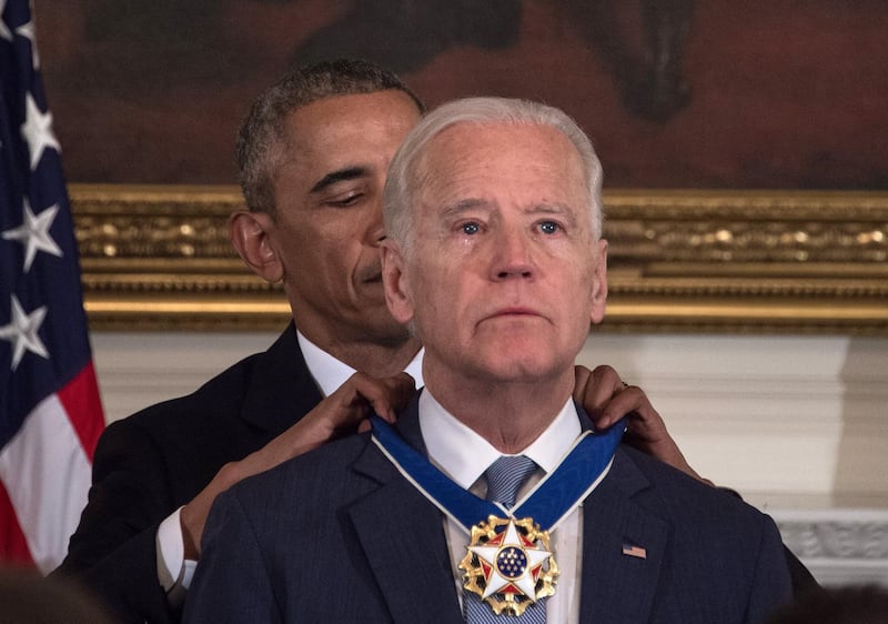 (FILES) In this file photo taken on January 12, 2017 US President Barack Obama awards Vice President Joe Biden the Presidential Medal of Freedom during a tribute to Biden at the White House in Washington, DC. He has suffered profound personal tragedy and seen his earlier political ambitions thwarted, but veteran Democrat Joe Biden hopes his pledge to unify Americans will deliver him the presidency after nearly half a century in Washington / AFP / NICHOLAS KAMM
