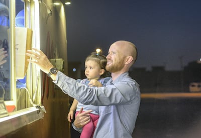 Abu Dhabi, United Arab Emirates - Christopher Dysart from Scotland with his daughter Shae,   usually visit the food trucks to pick up something quick on May 23, 2018. (Khushnum Bhandari/ The National)