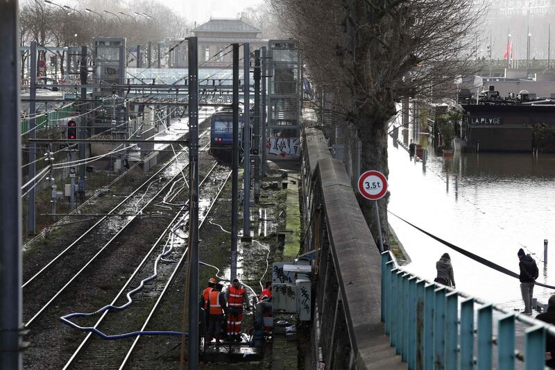 Workers pump water from the Javel railway station, flooded due to the high level of the Seine River in Paris. Ludovic Marin / AFP