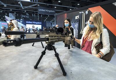 Abu Dhabi, United Arab Emirates, February 21, 2021.  Idex 2021, the first major in-person exhibition held in Abu Dhabi since the start of the Covid-19 pandemic, opened its doors to delegates on Sunday morning.  Visitors look at some UAE firepower by Caracal International LLC.
Victor Besa / The National
Section:  NA
Reporter:  John Dennehy