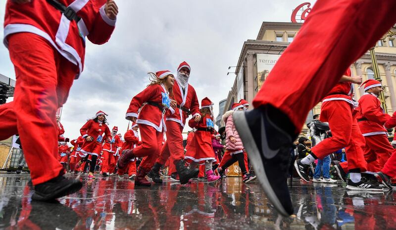 People dressed as Santa Claus run on the start of the Santa race in Skopje, Republic of North Macedonia.  EPA