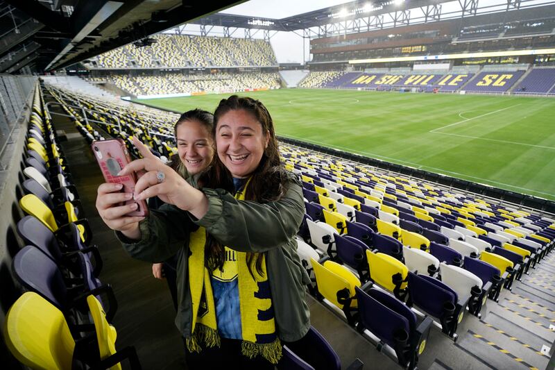 Football fans Caleigh and Chloe Castorena take a selfie at their home team's new stadium in Nashville, Tennessee. AP