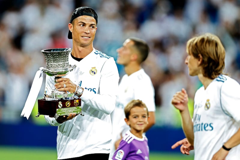 Real Madrid's Cristiano Ronaldo holds the trophy while celebrating with teammates after winning the Spanish Super Cup against Barcelona at the Santiago Bernabeu Stadium in Madrid, Thursday, Aug. 17, 2017. Real Madrid won 5-1 on aggregate. (AP Photo/Francisco Seco)