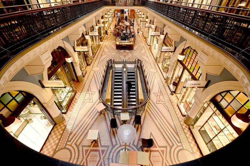 People walk through an empty shopping mall in the central business district of Sydney as people begin to stay at home due to fears over the coronavirus.   AFP