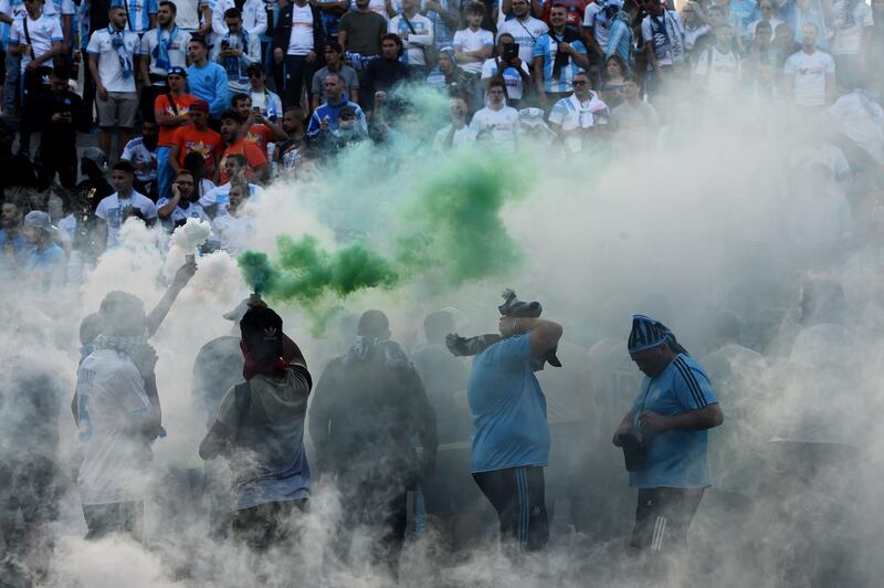 Marseille's supporters burn flares outside the Stade Velodrome. Boris Horvat / AFP Photo