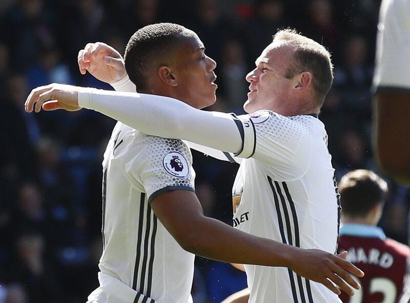Manchester United's Anthony Martial celebrates with Wayne Rooney after United's first of two goals against Burnley on Sunday at Turf Moor. Jason Cairnduff / Reuters