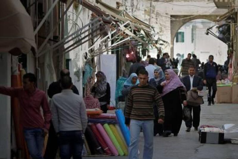 Libyans shop at a market in Tripoli's old city on April 12, 2011, as the European Union added to its Libya sanctions list 26 energy firms accused of financing Moamer Kadhafi's regime, a move that Germany said amounted to a de facto oil and gas embargo.  AFP PHOTO/JOSEPH EID
 *** Local Caption ***  768920-01-08.jpg