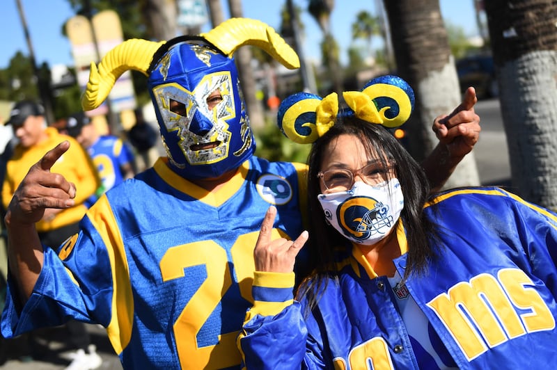 Fans celebrate outside of Los Angeles Memorial Coliseum during the Rams' victory parade. AFP