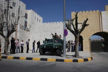 Men line up outside the Jordan state security court in Amman, Jordan on Sun. June 18, 2017. The fathers of two of the three American soldiers who were shot dead at a Jordanian military base are attending the latest hearing in the trial of the Jordanian serviceman accused of killing them. Brian McEnroe and James Moriarty traveled to Amman to attend Sunday's hearing in a state security court. (AP Photo/Sam McNeil)