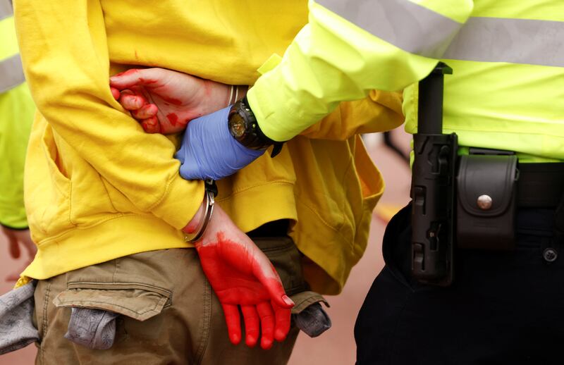 Caught red-handed ...a police officer detains an activist near Buckingham Palace. Reuters