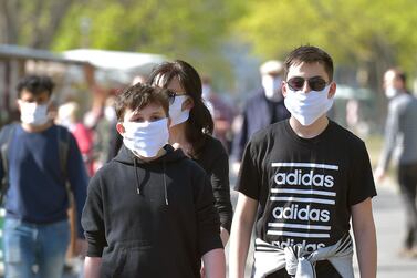 Visitors of a weekly market wear protective masks, as the spread of the coronavirus disease (COVID-19) continues in Dresden. Reuters
