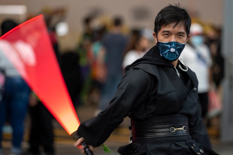 A Jedi shows off his lightsaber skills during New York Comic Con. Charles Sykes / Invision / AP