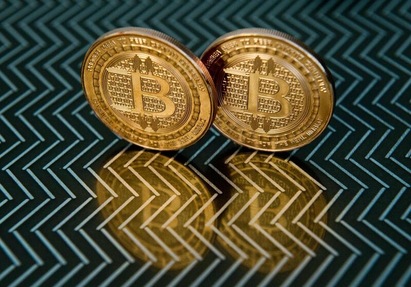 (FILES) This June 17, 2014 file photo taken in Washington, DC shows bitcoin medals. 
Bitcoin surged above $11,000 for the first time on November 29, 2017 as it extends a stratospheric rise that has delighted investors but sparked fears of a bubble.The virtual currency achieved its first landmark of a historic day early in the Asian trading session, breaching $10,000 for the first time, according to Bloomberg News figures. 
 / AFP PHOTO / KAREN BLEIER