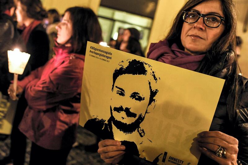 Activists of human rights organization Amnesty International hold a picture of Giulio Regeni and candles as they take part in a demonstration in front of Montecitorio, the Italian Parliament, in Rome on January 25, 2017, to mark the first anniversary since the disappearance of Italian student Giulio Regeni.  
Regeni, a 28-year-old Cambridge University PhD student from Italy, disappeared on January 25, 2016, in central Cairo, as police were out in force in anticipation of protests that day. His body was later found by the side of a road bearing signs of torture. He had been researching street vendor trade unions, an especially sensitive political issue in Egypt, with successive governments fearing strikes and unrest. Egypt has forcefully denied that its police were involved in his abduction. / AFP PHOTO / ANDREAS SOLARO