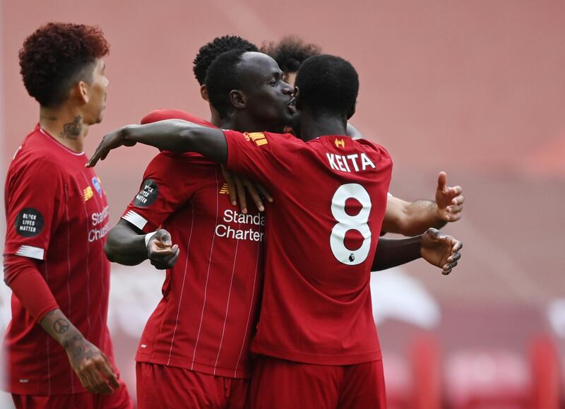 epa08529316 Sadio Mane of Liverpool (C) celebrates with teammate Naby Keita (R) after scoring his team's first goal during the English Premier League soccer match between Liverpool FC and Aston Villa at Anfield stadium in Liverpool, Britain, 05 July 2020.  EPA/Shaun Botterill/NMC/Pool EDITORIAL USE ONLY. No use with unauthorized audio, video, data, fixture lists, club/league logos or 'live' services. Online in-match use limited to 120 images, no video emulation. No use in betting, games or single club/league/player publications.