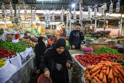 Customers shop at the Al-Azhar food market in Cairo. Islam Safwat / Bloomberg