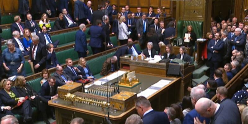 SNP and Conservative MPs walk out of the Commons chamber in the House of Commons in London. PA Wire