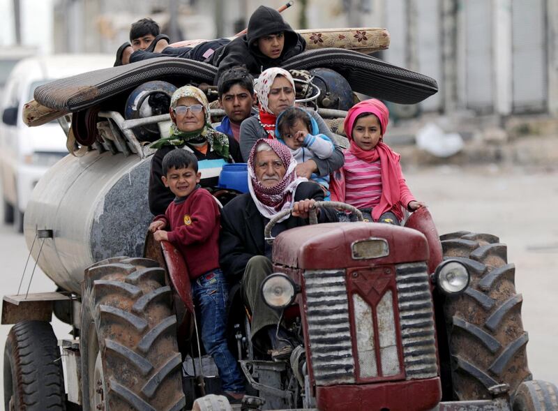 People flee after Turkish-backed Free Syrian Army fighters captured Khaldieh village in eastern Afrin, Syria on March 10, 2018. Khalil Ashawi / Reuters