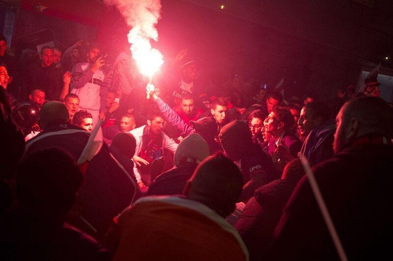 PSG supporters light a flare as they celebrate the club's Ligue 1 title in Paris on Wednesday. Kenzo Tribouillard / AFP / May 7, 2014