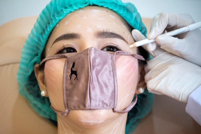 A customer wears a mini face mask during a treatment at the Waleerat beauty clinic after the Thai government eased isolation measures, amid the coronavirus disease (COVID-19) outbreak in Bangkok, Thailand. REUTERS