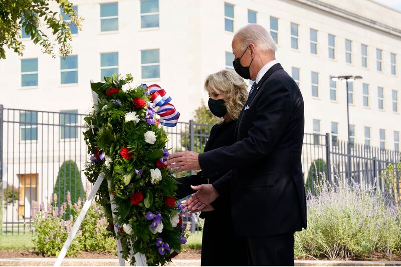 President Joe Biden and first lady Jill Biden participate in a wreath ceremony on the 20th anniversary of the terrorist attacks at the Pentagon in Washington, Saturday, Sept.  11, 2021, standing at the National 9/11 Pentagon Memorial site, which commemorates the lives lost at the Pentagon and onboard American Airlines Flight 77.  AP