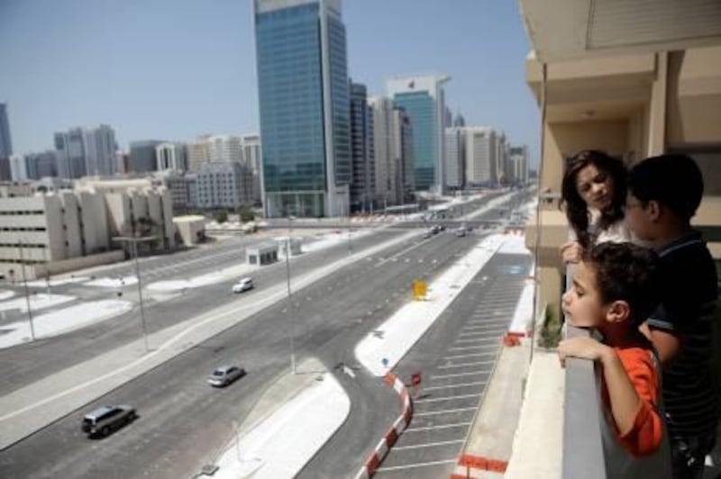 Sept 23, 2011 (Abu Dhabi) Ameera Osman, 16, Omar Osman, 12, and Ali Osman, 5, look out over their balcony overlooking Salam Street in Abu Dhabi which to traffic Friday September 23, 2011. (Sammy Dallal / The National)