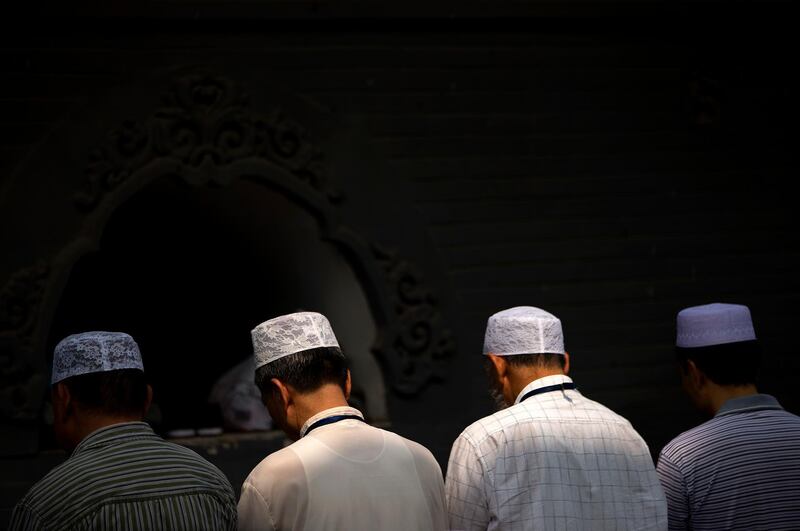 FILE - In this July 18, 2015, file photo, Chinese Hui Muslims pray during Eid al-Fitr prayers at Niujie Mosque in Beijing. Authorities in northwestern China were poised to begin demolition of a mosque Friday, Aug. 10, 2018, despite protests by hundreds of members of the country's Muslim Hui ethnic minority determined to preserve the newly built structure. (AP Photo/Mark Schiefelbein, File)