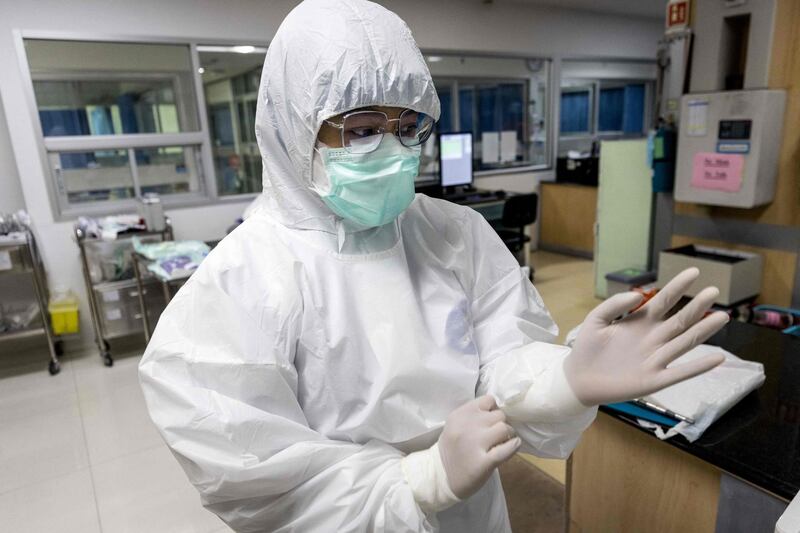 A nurse wearing a personal protective equipment gets ready for work at the Covid-19 intensive care unit of Vibhavadi Hospital in the Thai capital Bangkok. AFP