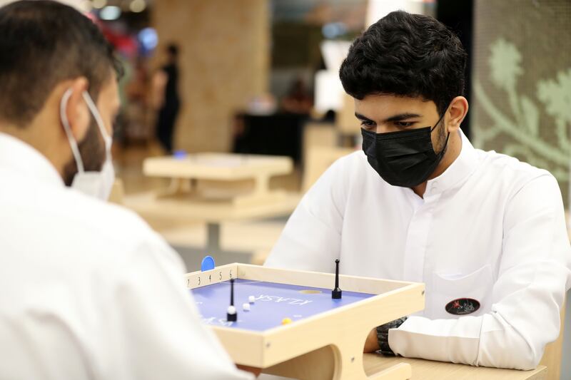 Visitors plays Klask which is a dexterity game.